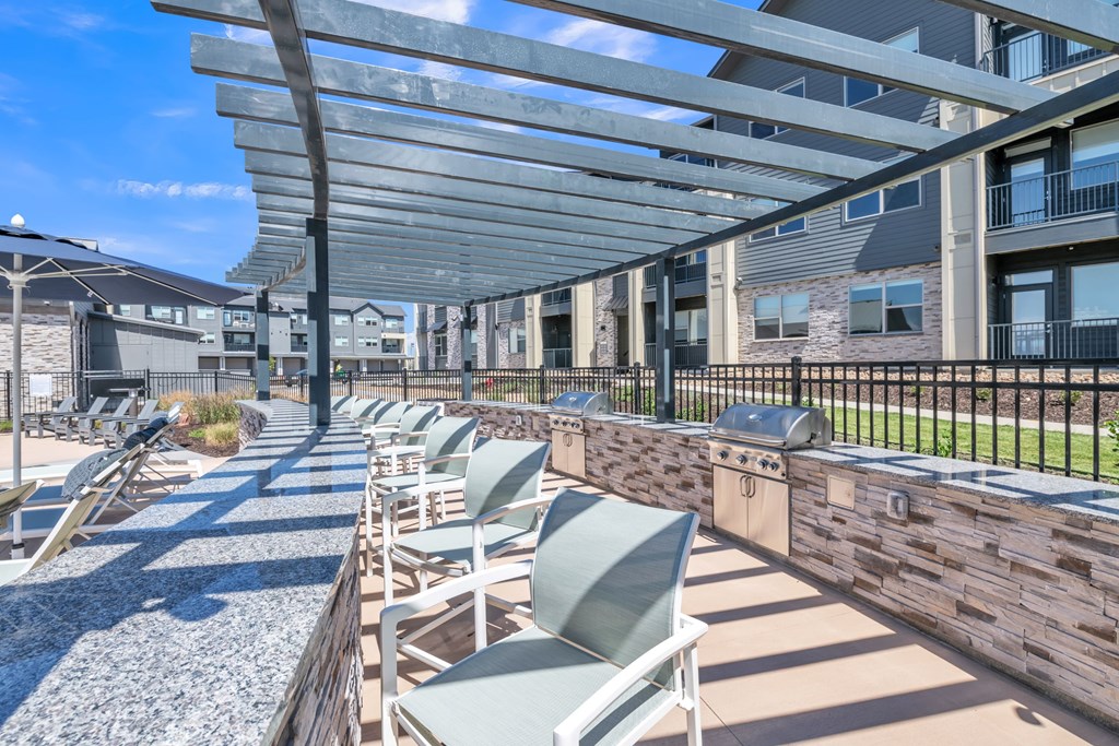 A row of chairs are lined up on a patio.