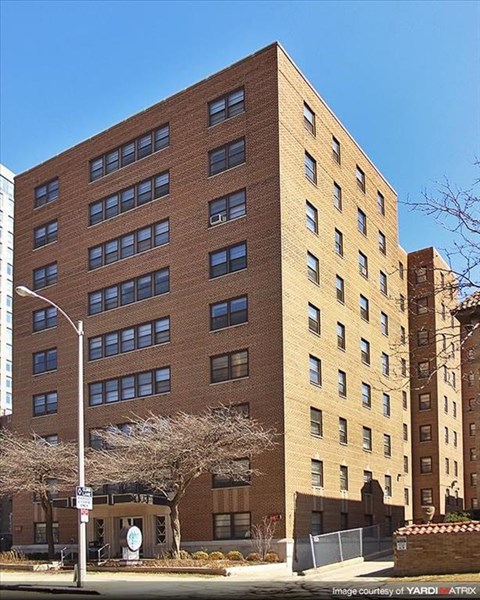 a tall brick building on the side of a street