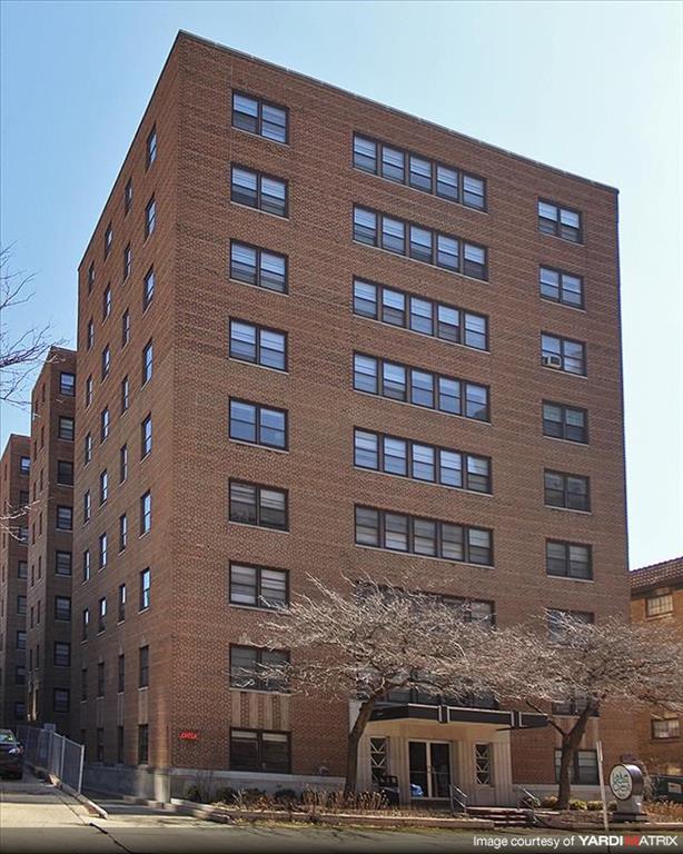 a tall brick building with a lot of windows