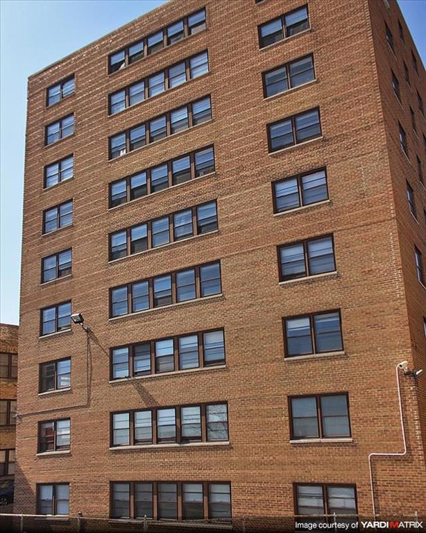 a tall brick building with many windows on it