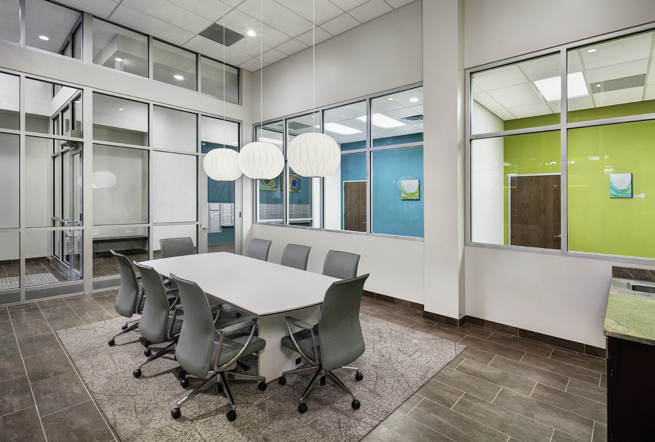 a conference room with a white table and chairs