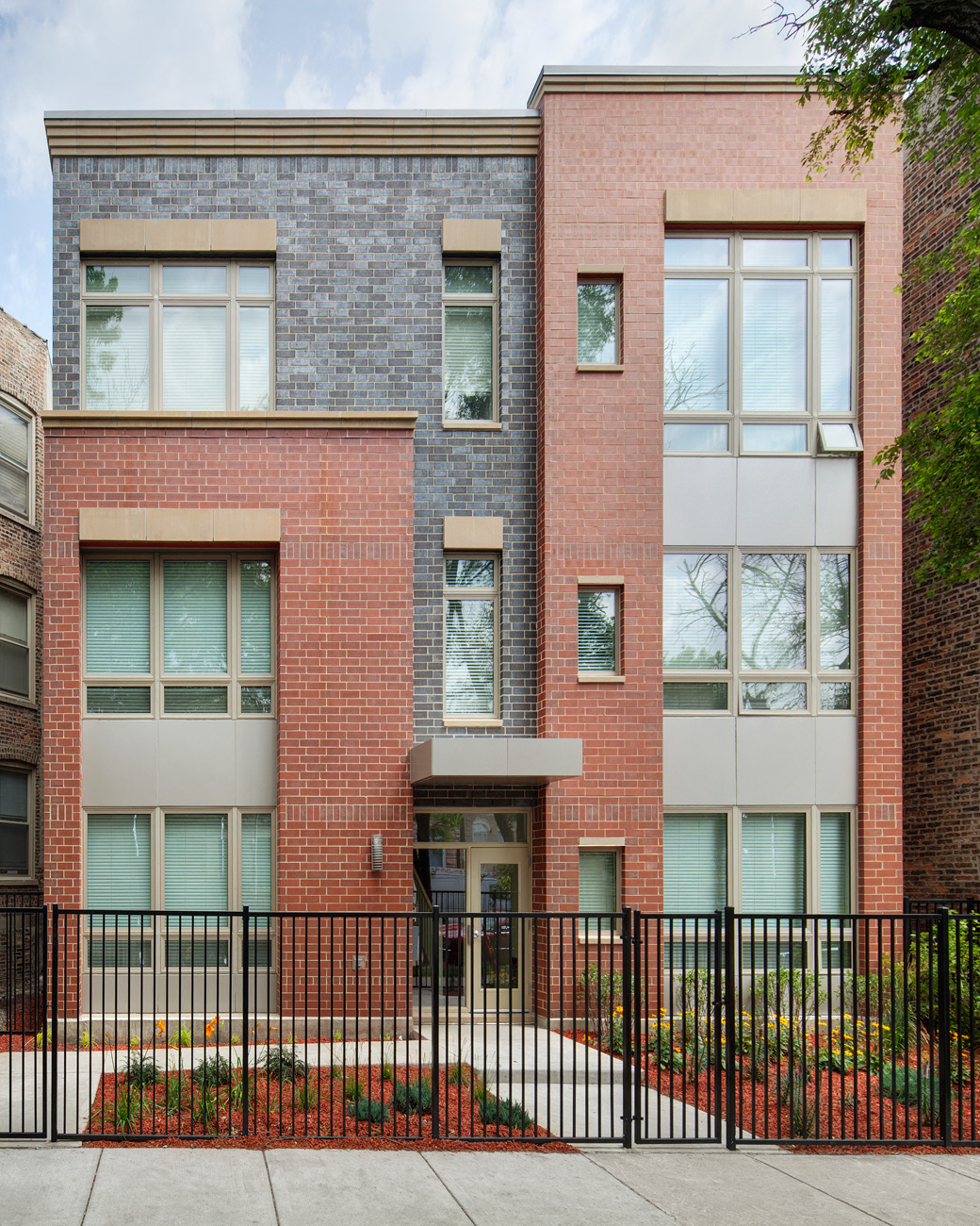 a red brick building with a gate in front of it