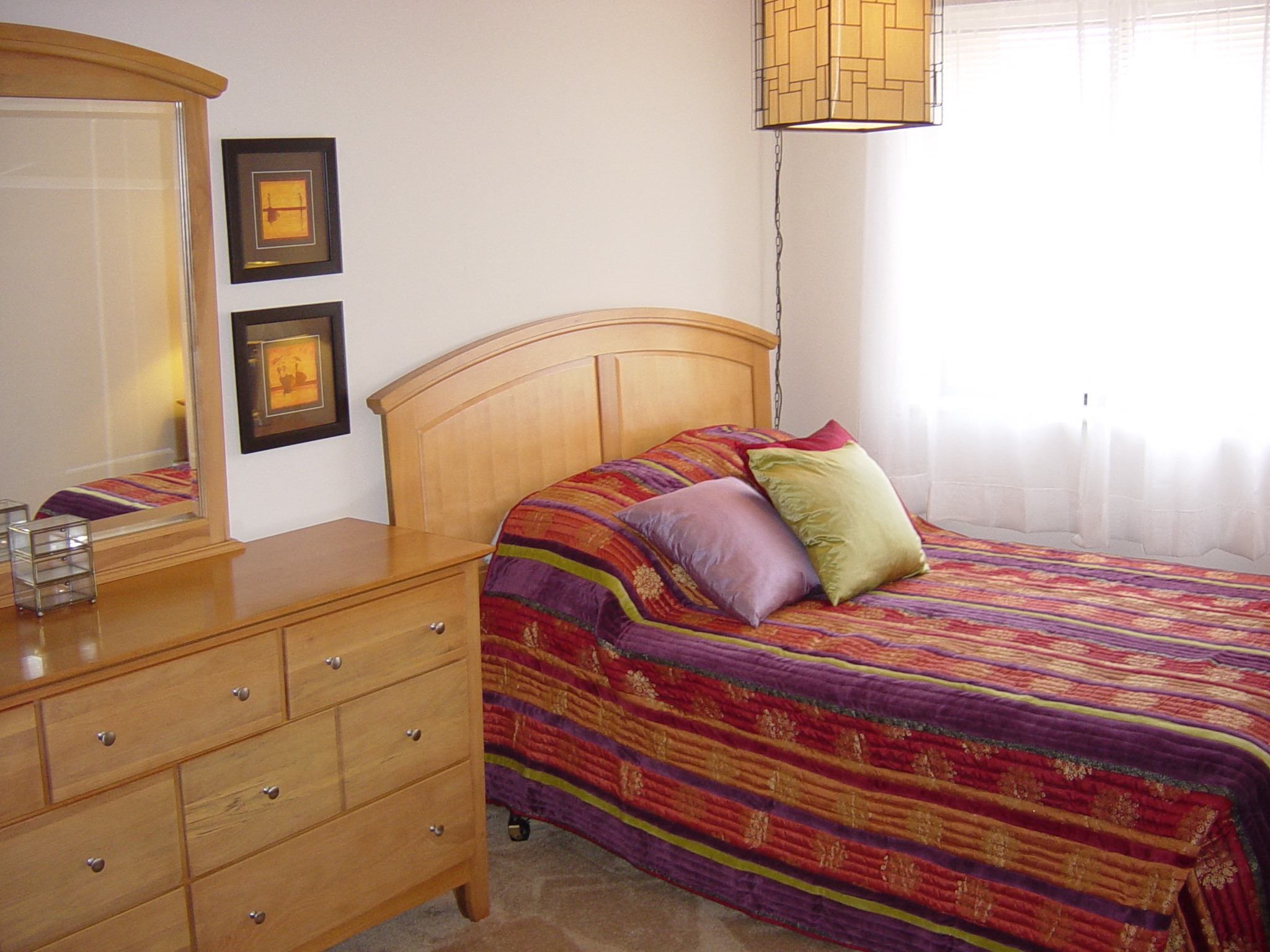 a bedroom with a bed and a dresser
