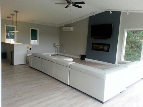 an open living room with white couches and a television