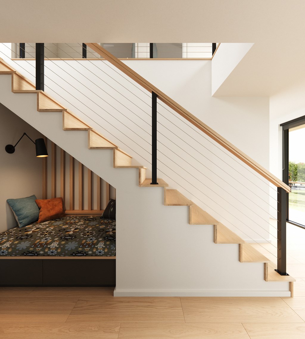 A bedroom with a bed and a staircase.