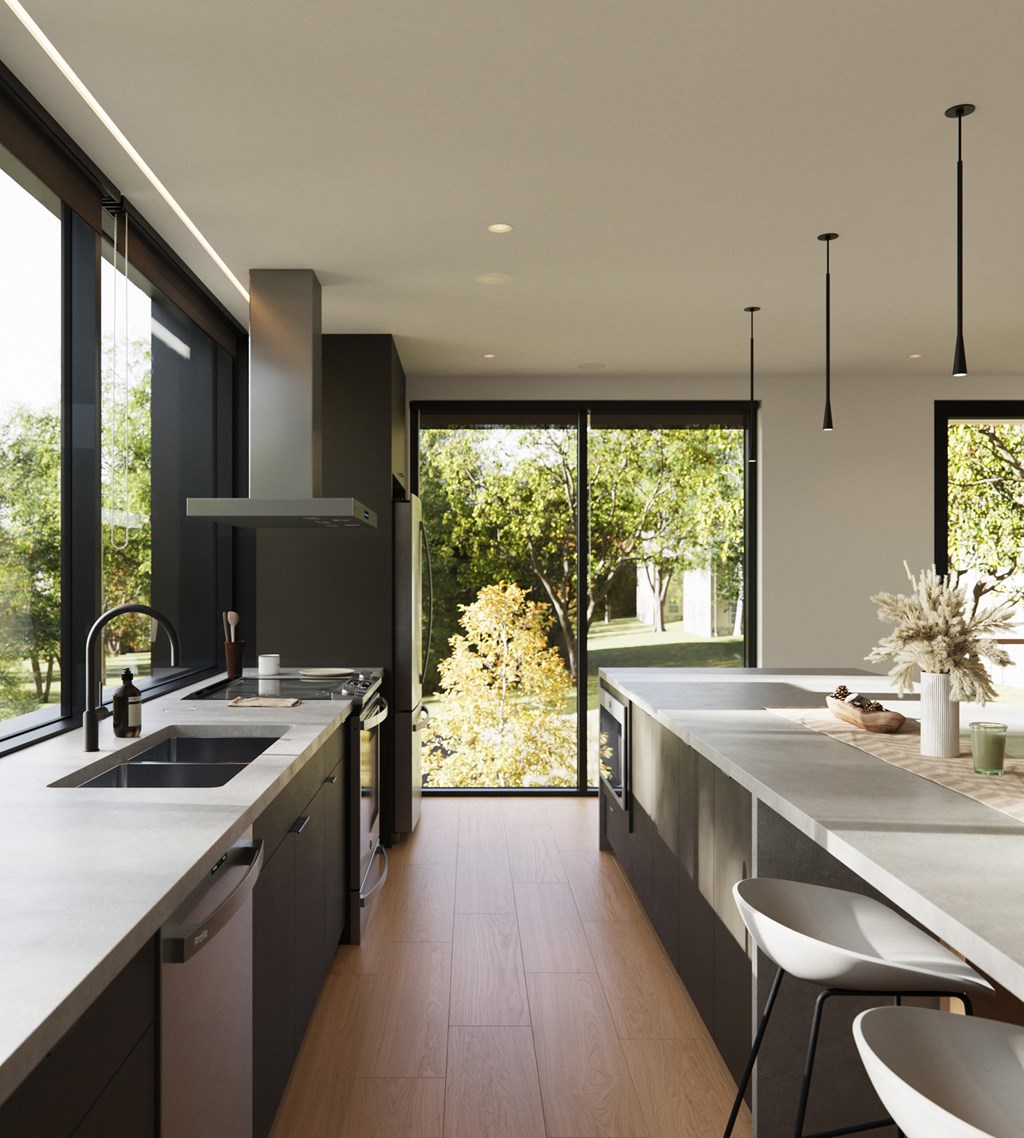 A modern kitchen with a large window overlooking a garden.