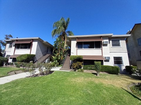 A house with a green lawn in front.