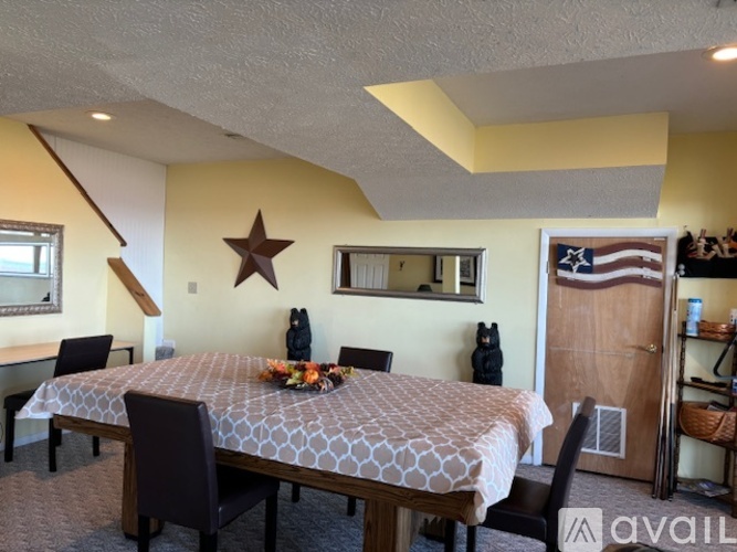 A dining room with a table set for six.