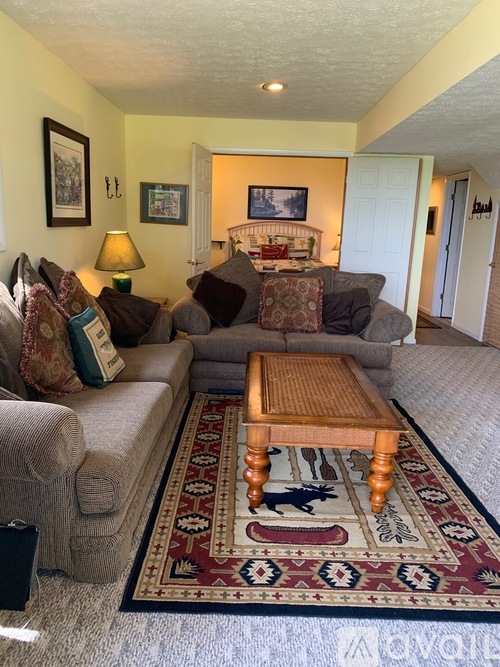 A living room with a rug and a couch.