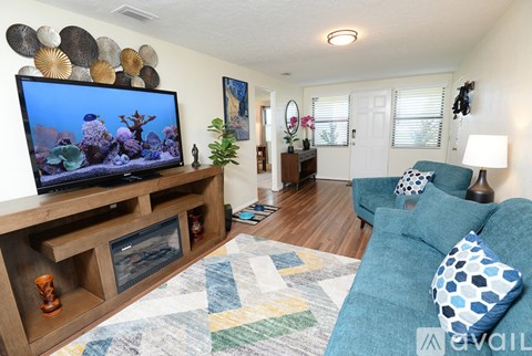 A living room with a television and a couch.