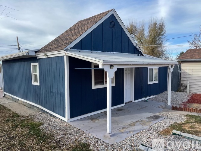 A blue house with a white porch.