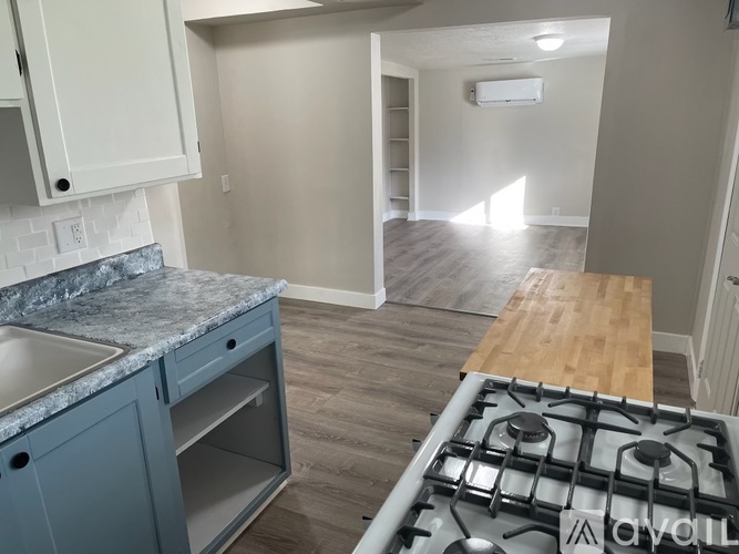 A kitchen with a granite countertop and a stove top oven.