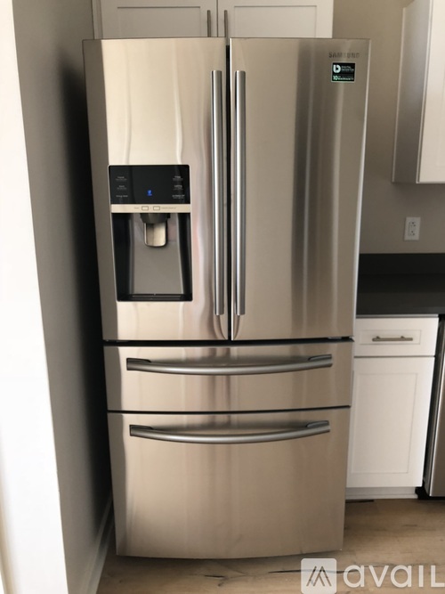 A stainless steel refrigerator with a water and ice dispenser on the door.