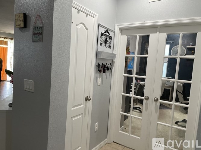 A white door with a glass window is open.