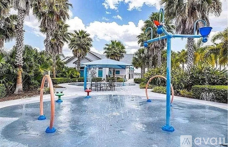 A playground with a blue pole and a slide.