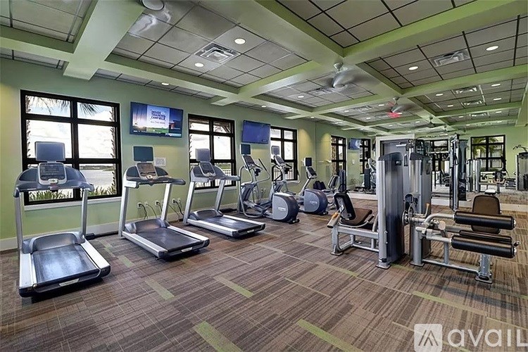 A gym with treadmills, exercise bikes, and other equipment.