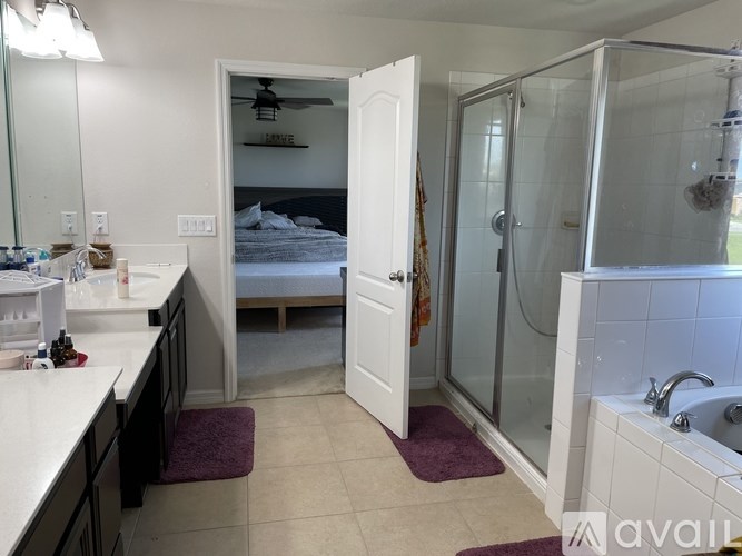 A bathroom with a white tub, sink, and shower.