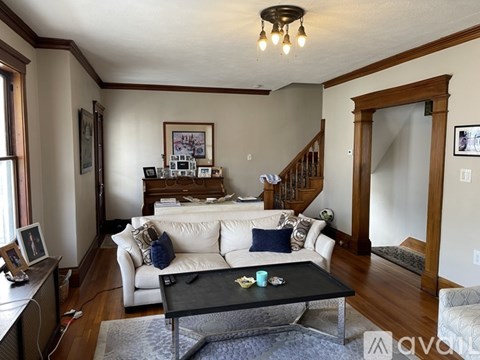 A living room with a white couch and a coffee table.