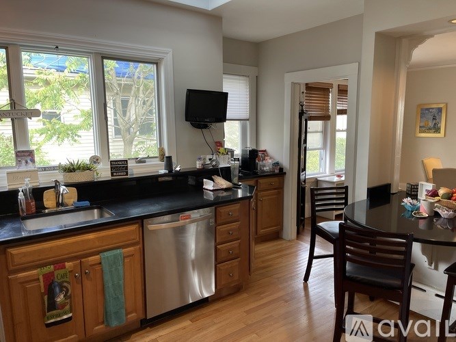 A kitchen with wooden cabinets and a black countertop.