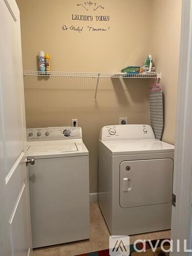 A small laundry room with a washer and dryer.