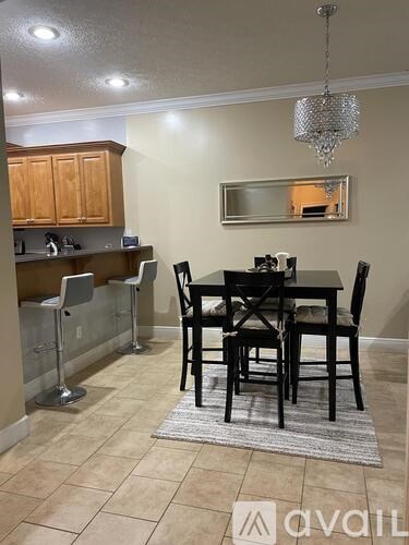 A dining room with a table set for four.