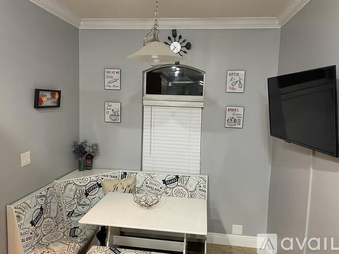 A room with a patterned couch and a fan.
