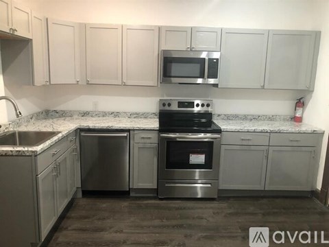A kitchen with a stove top oven and microwave above it.