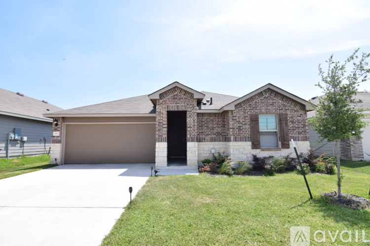 A house with a garage and a driveway in front.