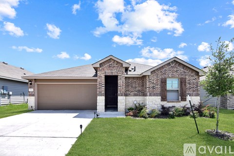 A house with a garage and a driveway in front.