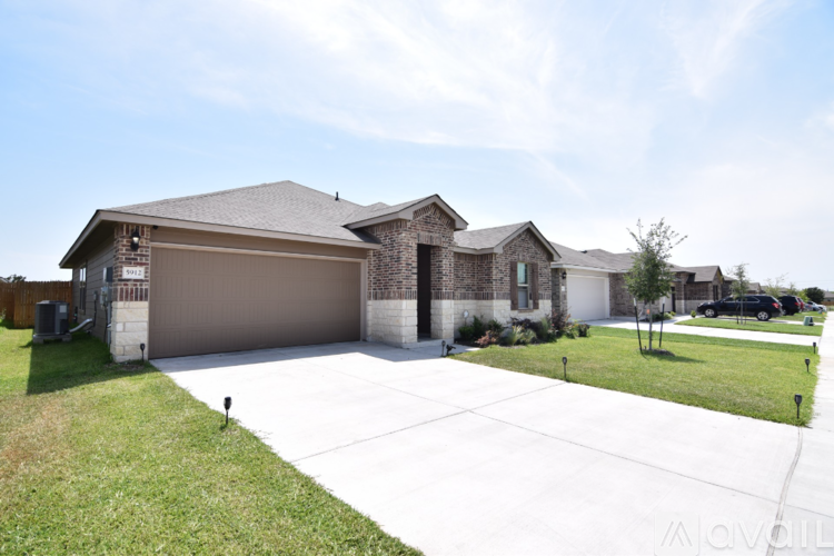 A house with a garage and a driveway is for sale.
