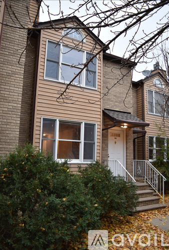 A two-story house with a white door and windows.