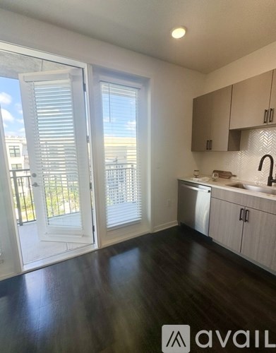 A kitchen with a white island and stainless steel appliances.