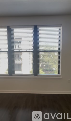 A bathroom with a glass shower door and a rug on the floor.