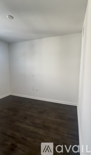 A room with a wooden floor and white walls.