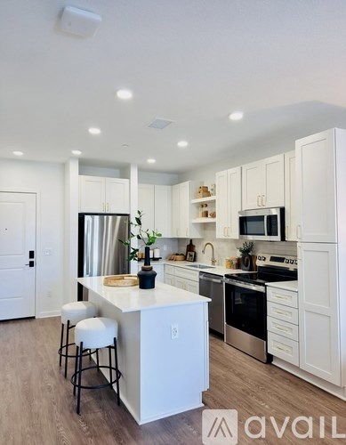 A kitchen with a stove top oven and a window.