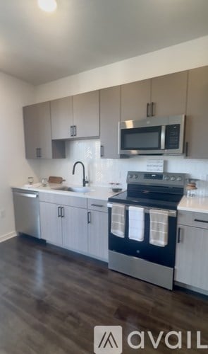 A kitchen with a sink, dishwasher, and microwave.