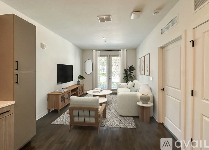 A living room with a couch, chair, and television.