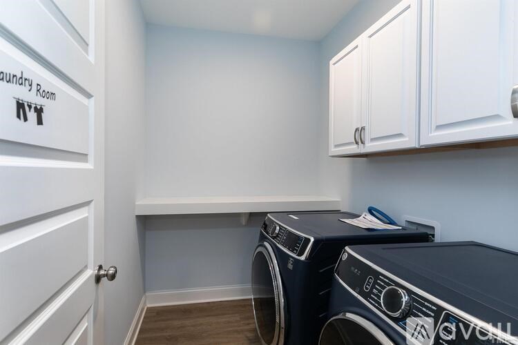 A laundry room with two front-loading washing machines.