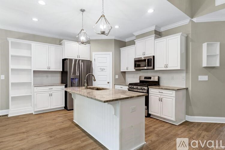 A kitchen with white cabinets and a central island.