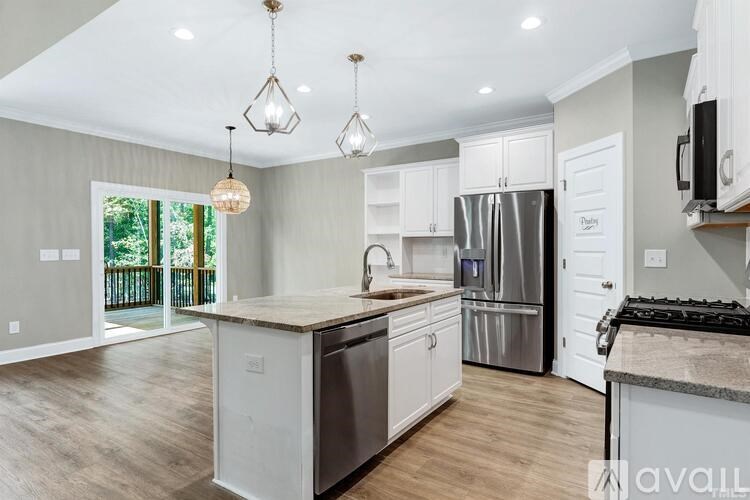 A modern kitchen with stainless steel appliances and wooden countertops.