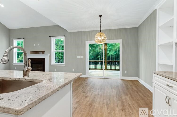 A kitchen with a marble countertop and a chandelier hanging from the ceiling.