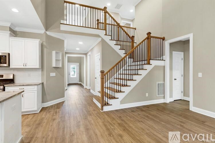 A spacious home interior with a staircase leading to the upper level.