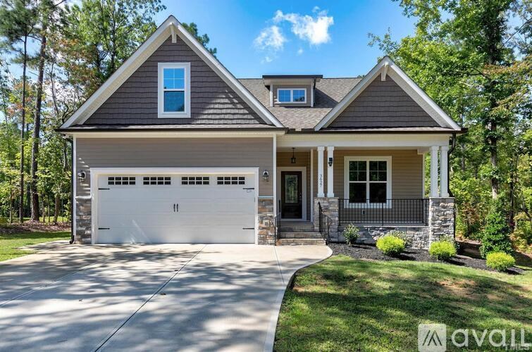 A two-story house with a garage is available for sale.