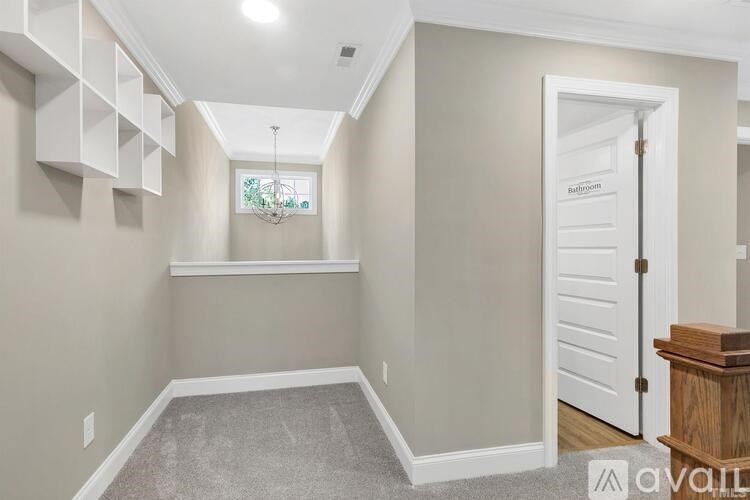A room with a carpeted floor and a white door.