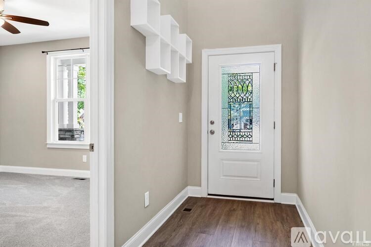 A room with a white door and a window.
