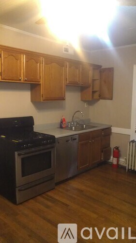 A kitchen with wooden cabinets and a black stove top.