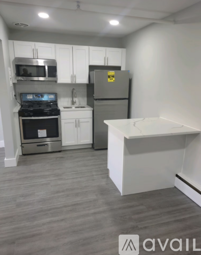 A kitchen with a stove, oven, refrigerator, and microwave.