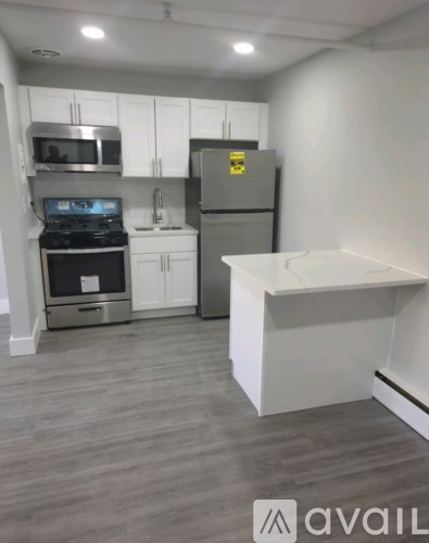 A kitchen with a stove, oven, refrigerator, and microwave.