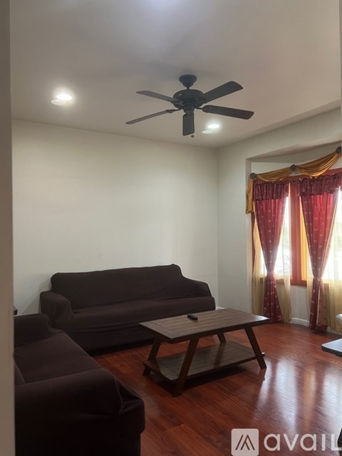 A living room with a brown sofa and a wooden coffee table.