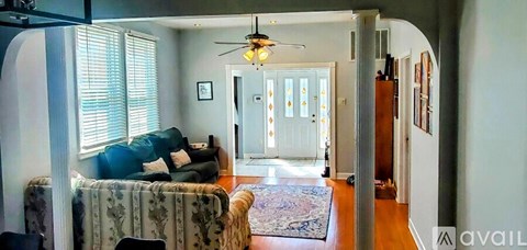A living room with a couch and a rug.